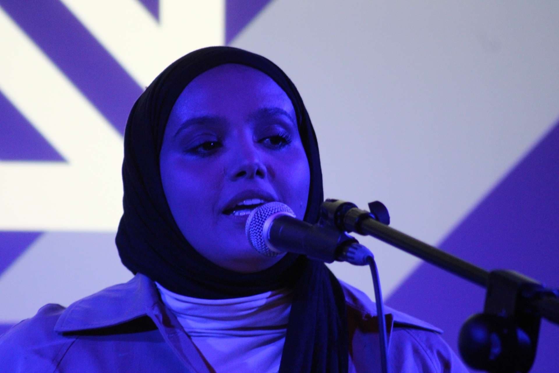 Lady performing at All Ears Poetry Event